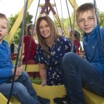 Elaine Baird with sons Myson and Wesley aboard the swingboats. JasMc4
