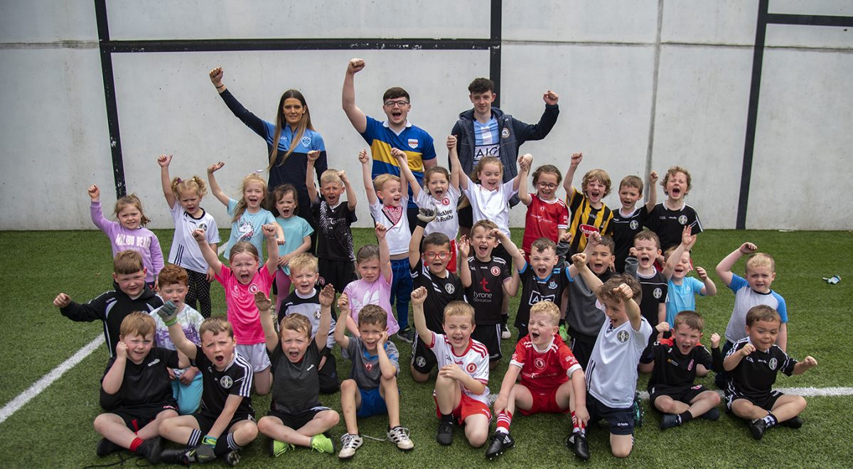 The 5-7 year old group and their coaches, Laura Corcoran, Ryan McCaul and Aaron McKernan raise a cheer. JasMc2