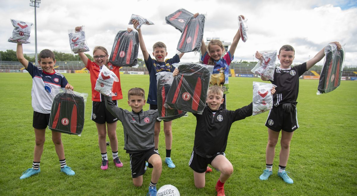 Happy young Gaels receive strips and kit bags as they celebrate the close of summer camp. JasMc3