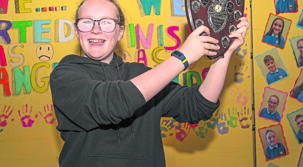 Girls marathon winner Emily holds aloft the Herdman's Shield. JasMc3