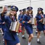 Ladies from Aghyaran Accordion Band catch a selfie as the parade passes along John Street. JasMc2