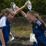 Friends Aoife McMackin and Ellen McCusker help each other cool down after their energetic 5k. JasMc4