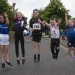 Quin, Cara, Padraic, Odhran and Rosie jump for joy as they approach the finish line. JasMc5