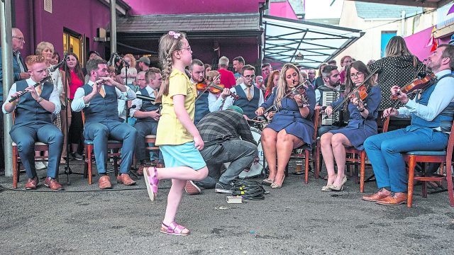 A young lady breaks into a dance during a performance by the Blackwater Céilí Band. JasMc5