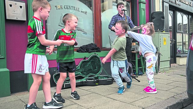 Children dance in the street during a performance by busker Darragh Murphy on Saturday afternoon. JasMc4
