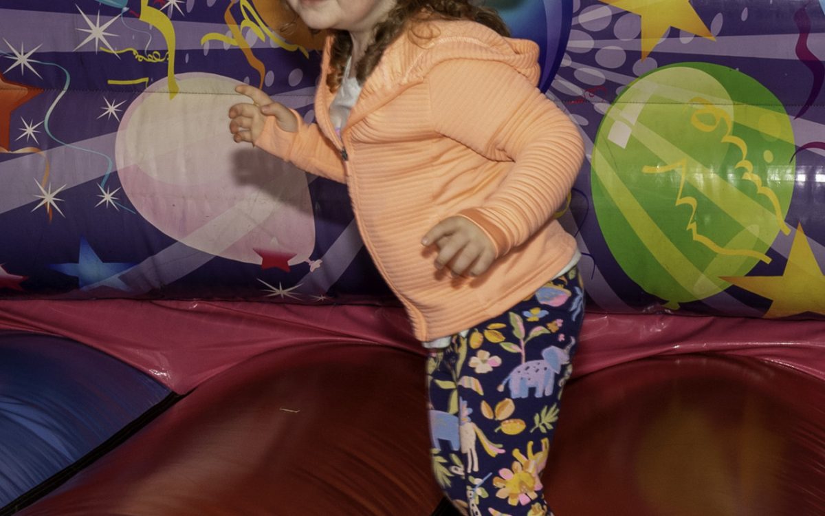 Bonnie Rouse having a ball bouncing on the bouncy castle.