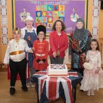 Langfield Principal Mrs Moore cuts the Coronation cake with Head of Canteen Caroline and fancy dress prize winners Freddie, Isla, Rihanna and Jethro. JasMc4
